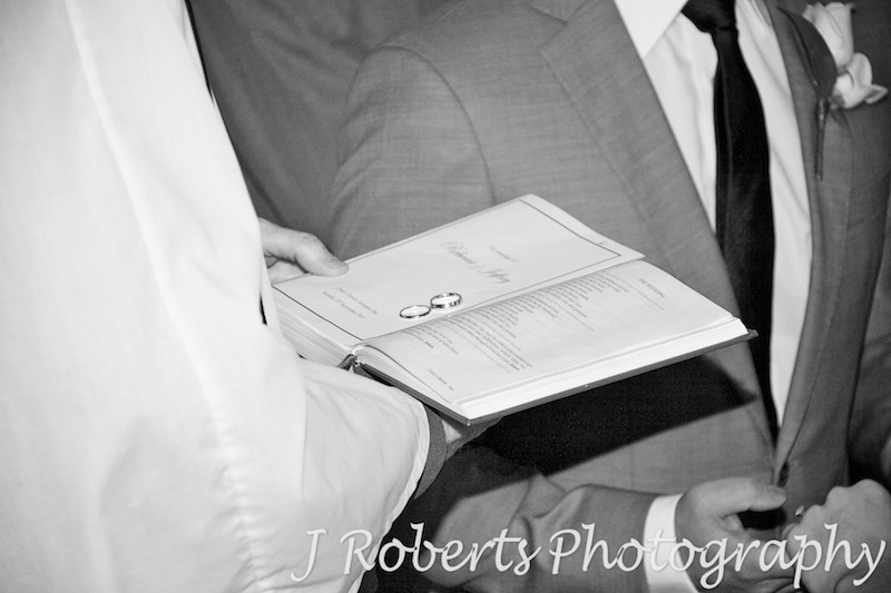 Wedding bands being blessed on the bible - wedding photography sydney